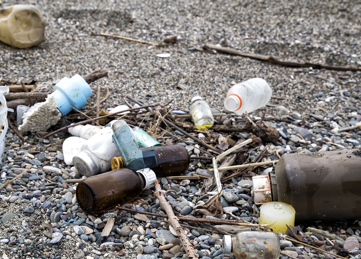 Plastic and medical waste materials at the beach. Single-use pla